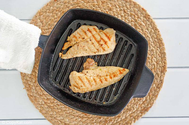 cooked chicken breasts in a grill pan