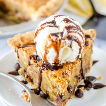 a slice of Toll House pie topped with ice cream and chocolate syrup