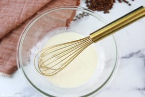 vanilla sweet cream mixture and a whisk in a bowl