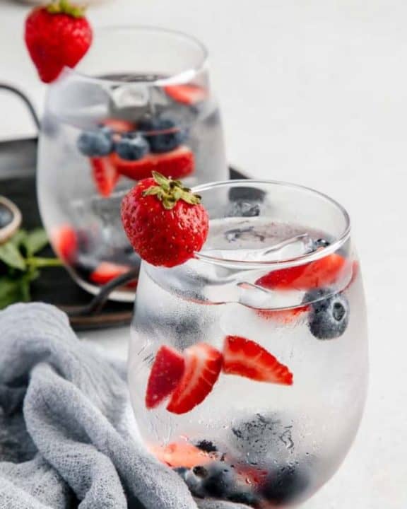 glasses of fruit infused water and fresh fruit.