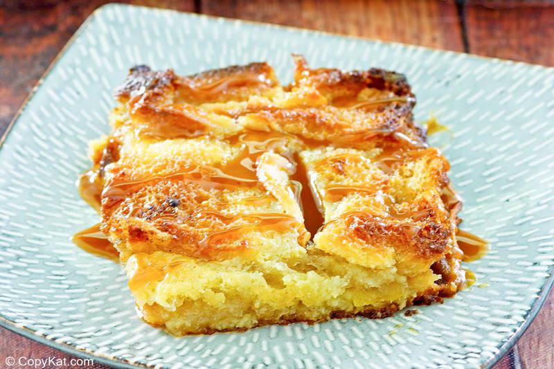 a serving of apple bread pudding with caramel sauce on a plate.