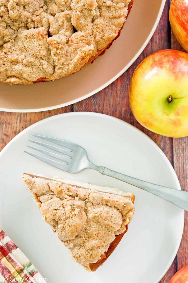 overhead view of apple coffee cake with crumb topping and apples.