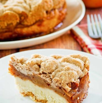 a slice of apple coffee cake with crumb topping on a plate.