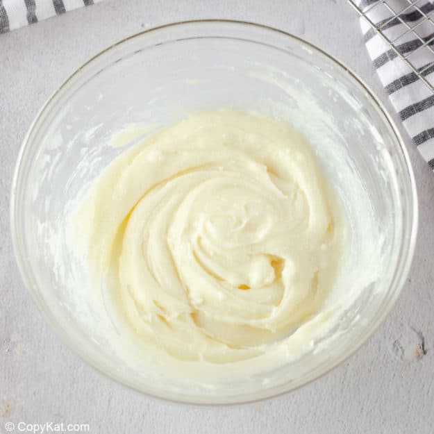 cream cheese frosting for apple spice cake in a bowl.