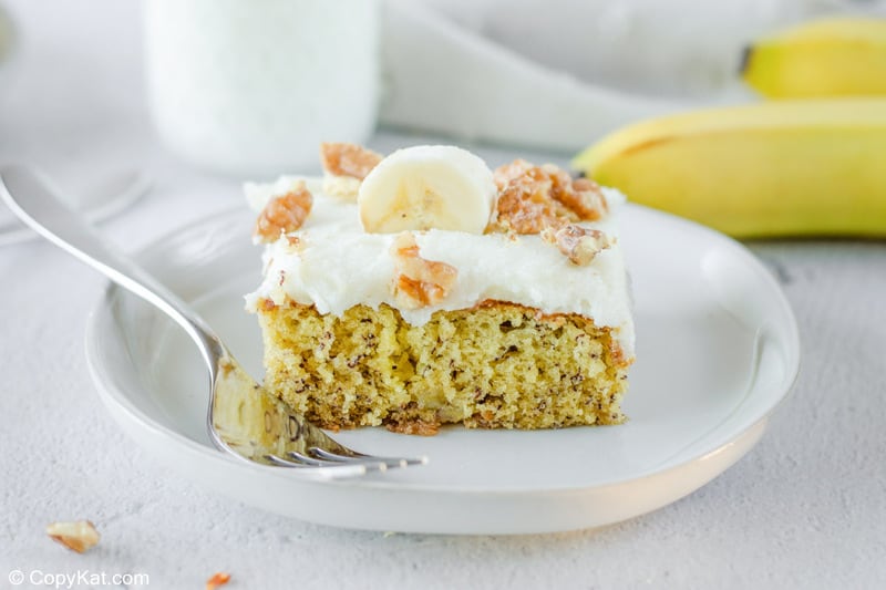 a slice of banana cake and a fork on a plate.