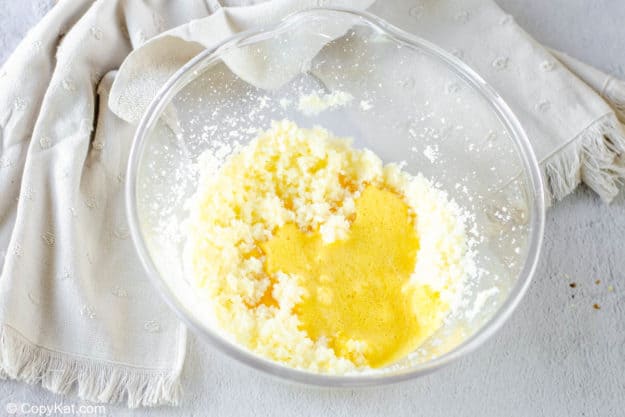 creamed butter and sugar and beaten eggs in a mixing bowl.