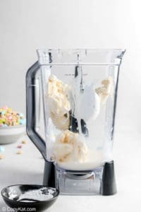 vanilla ice cream, milk, and marshmallow creme in a blender.