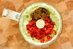 Rotel tomatoes, green chilies, and avocado mixture in a food processor.