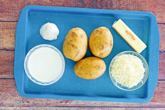 cheesy au gratin potatoes ingredients on a tray.