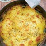 overhead view of cheesy au gratin potatoes in a skillet.