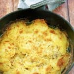 cheesy au gratin potatoes in a skillet.