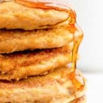 a stack of 5 homemade IHOP pumpkin pancakes with syrup running down the side.
