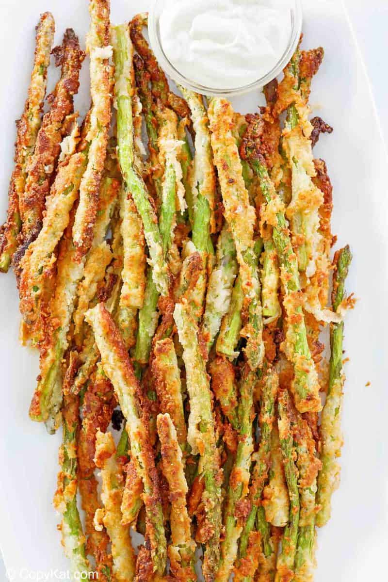 overhead view of homemade Longhorn Steakhouse parmesan crusted asparagus on a platter.