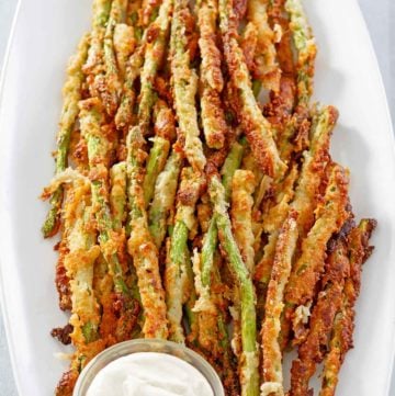 homemade Longhorn Steakhouse parmesan crusted asparagus on a platter.