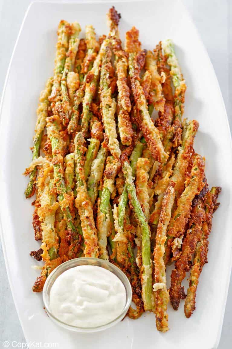 homemade Longhorn Steakhouse parmesan crusted asparagus on a platter.