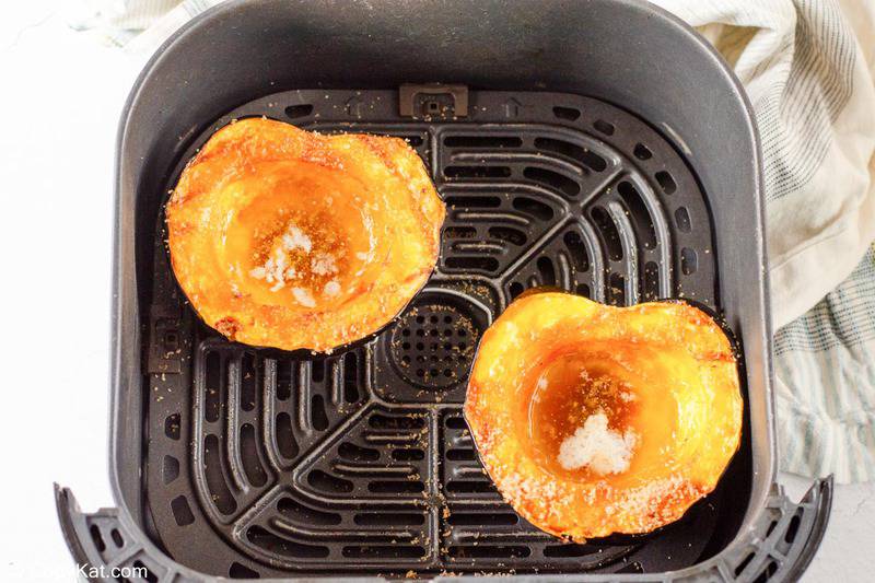 air fried acorn squash in an air fryer basket.