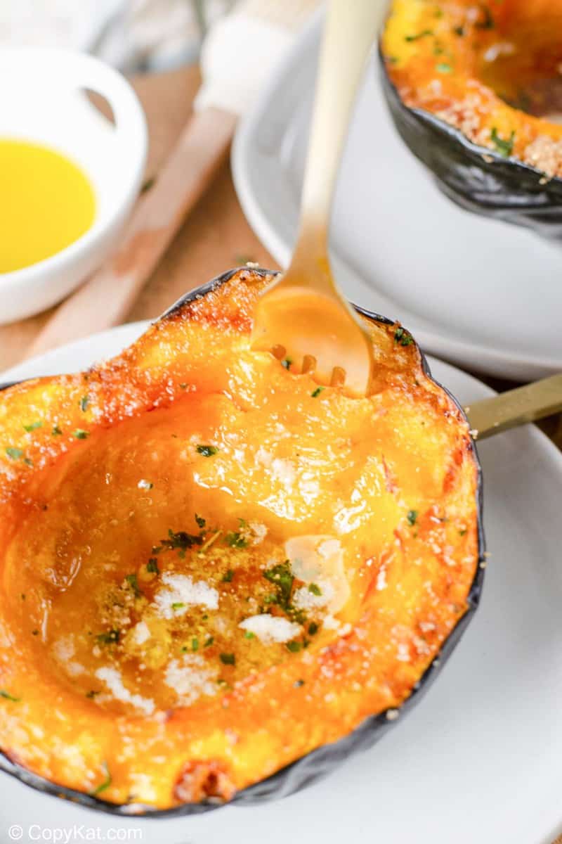 air fryer acorn squash with a fork in it.