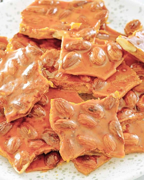 homemade almond brittle on a plate.