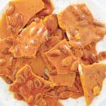 overhead view of homemade almond brittle on a plate.