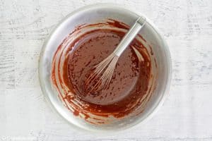 chocolate brownie batter and a whisk in a mixing bowl.