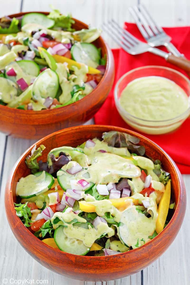 homemade Chick Fil A avocado lime ranch dressing on salad and in a bowl.