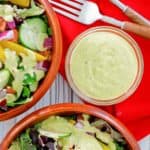 homemade Chick Fil A avocado lime ranch dressing in a bowl and on salads.