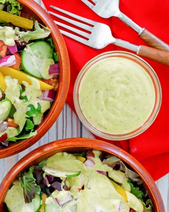 homemade Chick Fil A avocado lime ranch dressing in a bowl and on salads.