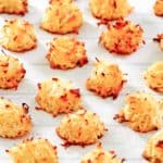 coconut macaroons scattered on parchment paper.