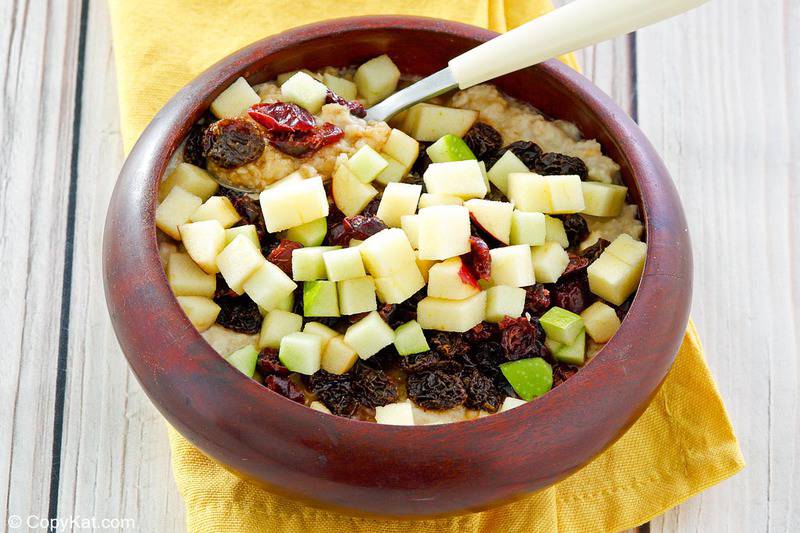 homemade McDonald's fruit and maple oatmeal and a spoon in a bowl.