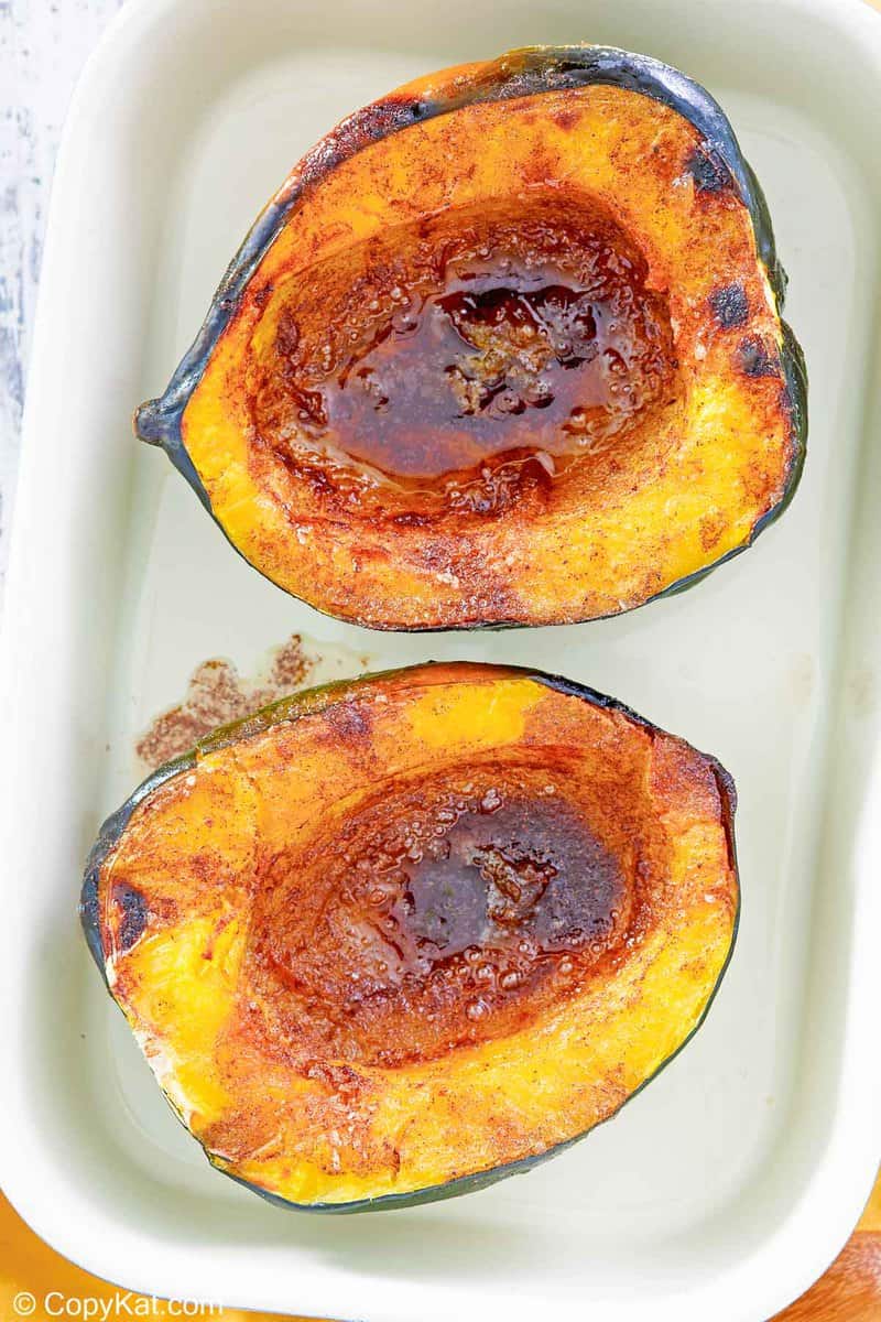 overhead view of microwave acorn squash with brown sugar butter sauce.