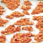 microwave peanut brittle candy pieces on a baking sheet.