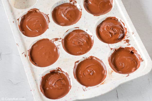 homemade Reese's peanut butter cups in a muffin pan.