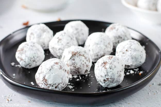 rum balls coated with powdered sugar on a plate.