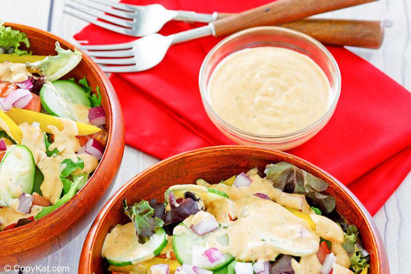 two forks, southwestern ranch dressing in a bowl and on salads.