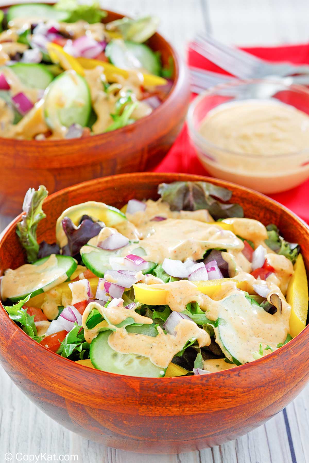 southwestern ranch dressing on salads and in a small bowl.