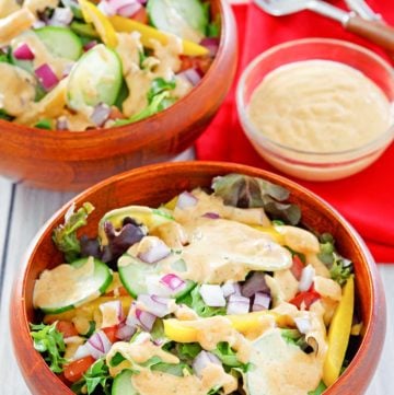 southwestern ranch dressing in a small bowl and on two salads.