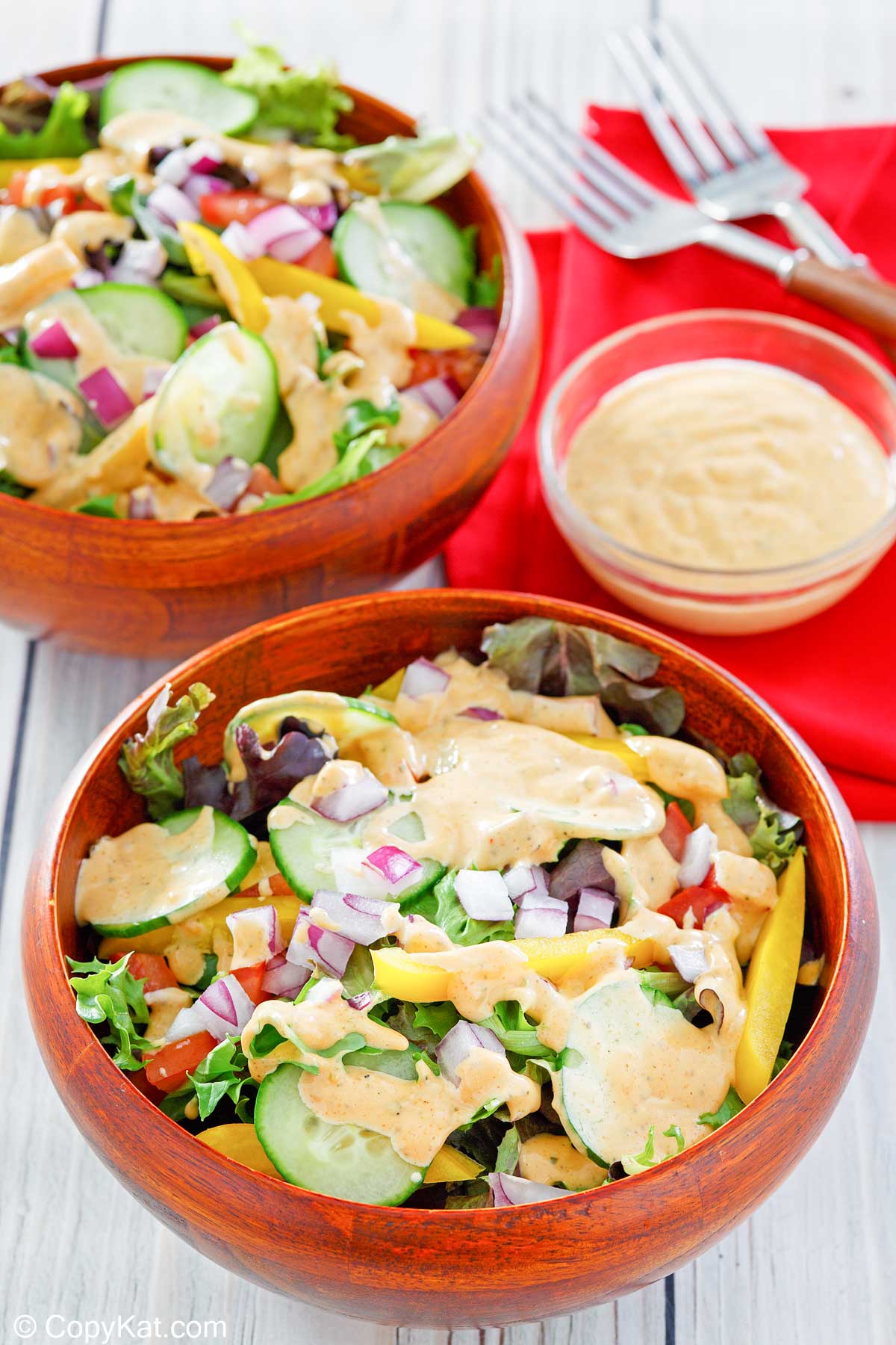 southwestern ranch dressing in a small bowl and on two salads.