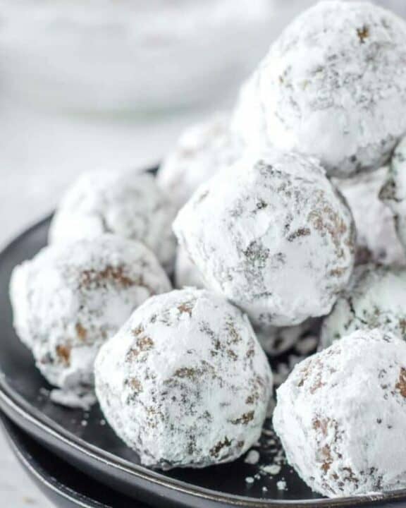 a pile of rum balls on a plate.