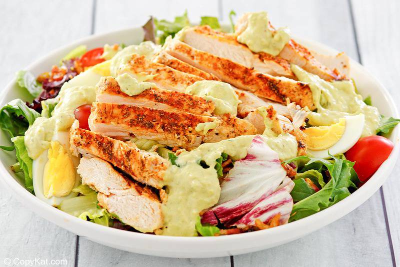 a bowl of homemade Chick Fil A cobb salad with dressing.