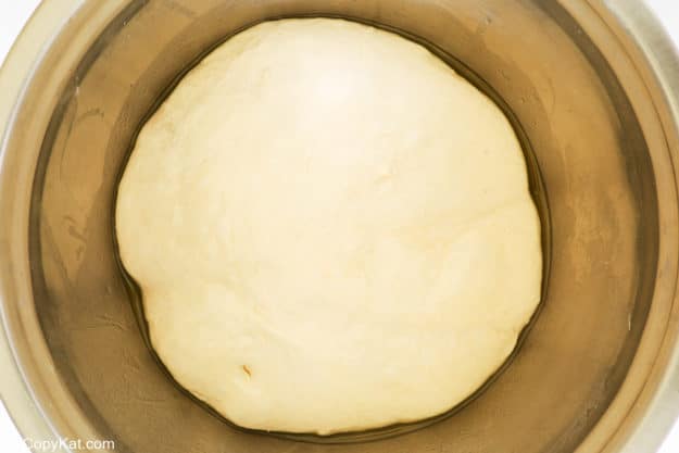 homemade pizza dough ball in a bowl.