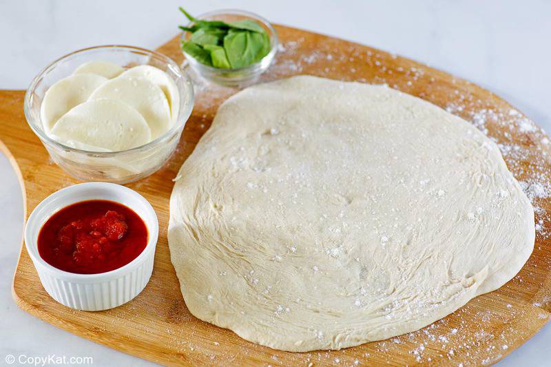 homemade pizza dough on a pizza peel.