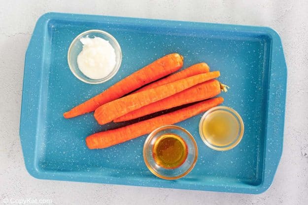 honey roasted carrots ingredients on a tray.