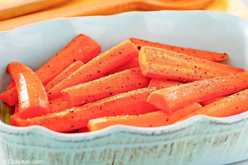 honey roasted carrots in a light blue serving dish.