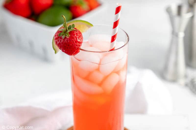 homemade Olive Garden Italian Rum Punch garnished with a lime wedge and strawberry.