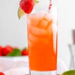 Homemade Olive Garden Italian Rum Punch portion  garnished with strawberry and lime.