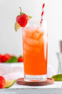 Homemade Olive Garden Italian Rum Punch drink garnished with strawberry and lime.