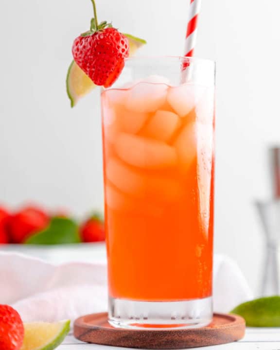Homemade Olive Garden Italian Rum Punch drink garnished with strawberry and lime.