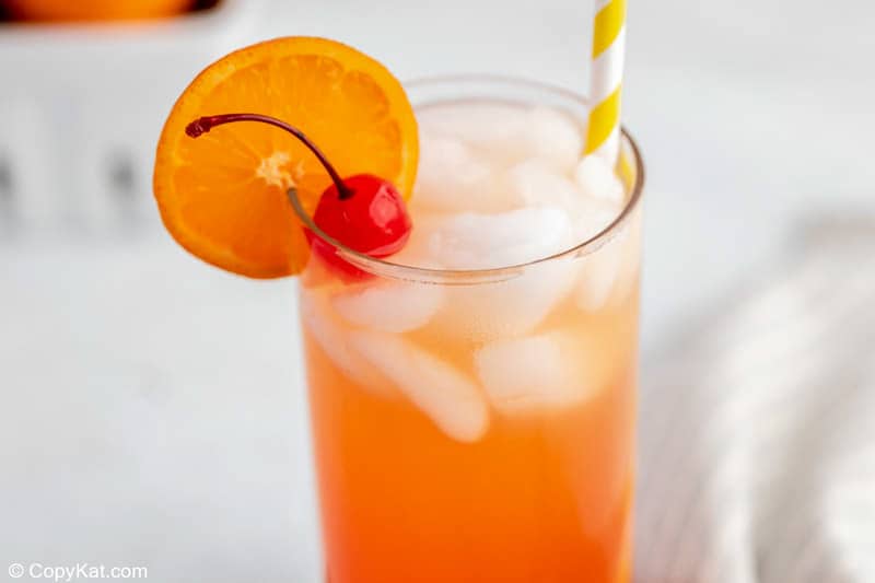 homemade Olive Garden Venetian Sunset drink garnishes with an orange slice and cherry.