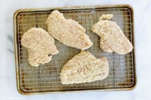 panko breaded chicken breasts on a wire rack.