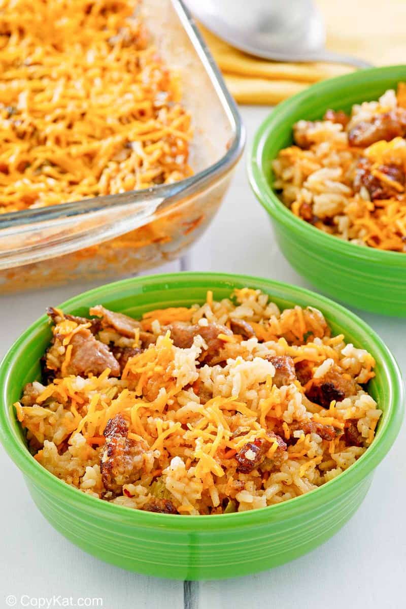 sausage and rice casserole in two bowls and a baking dish.